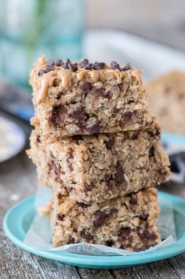 Three stacked Healthy Peanut Butter Chocolate Chip Quinoa Bars on a small blue plate.