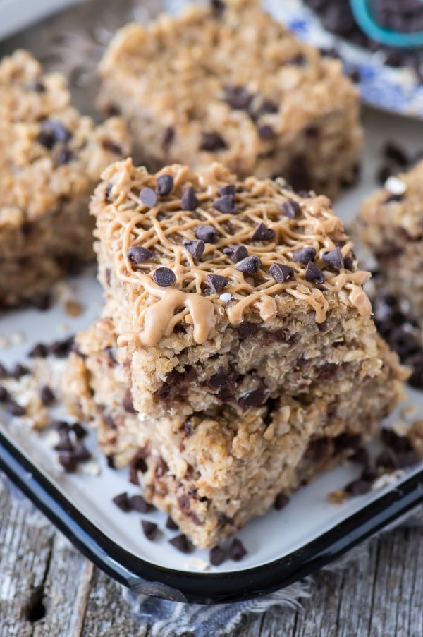 Healthy Peanut Butter Chocolate Chip Quinoa Bars drizzled with peanut butter on a baking dish.