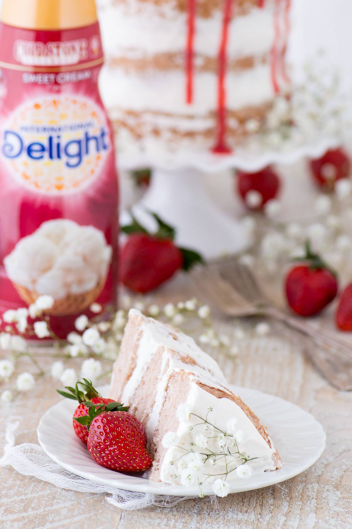 This strawberry naked cake is made with fresh pureed strawberries and is paired with homemade sweet cream whipped cream! Like a strawberries and cream cake!