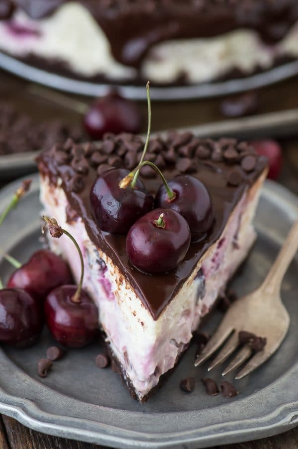 Fresh chocolate cherry cheesecake recipe with a chocolate crust, fresh cherries baked into the cheesecake, dripping with ganache. 