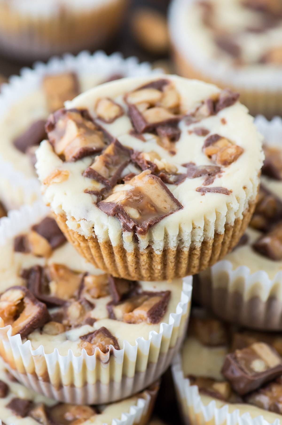 7 ingredient mini snicker’s cheesecake recipe made in a muffin pan!