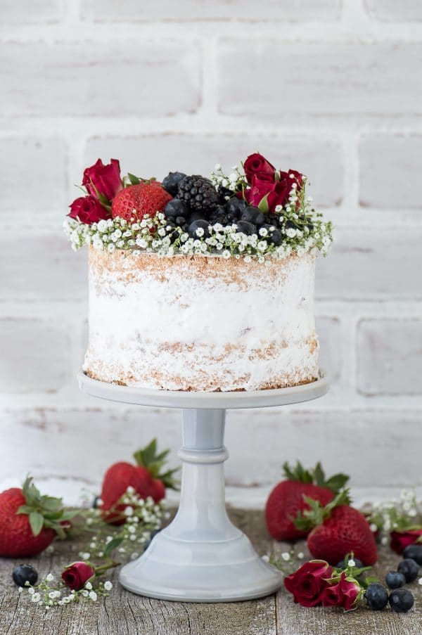 Naked berry ice cream cake recipe. A naked cake featuring 2 layers of vanilla bean cake and a layer of homemade vanilla bean berry ice cream. 