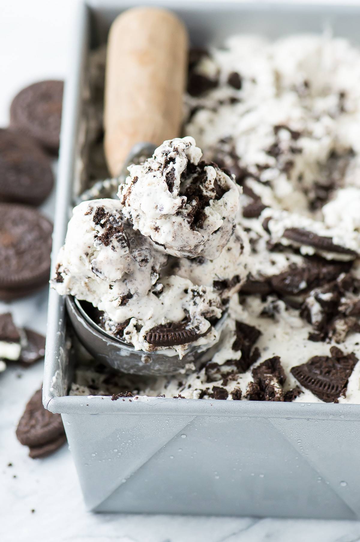 Scooping easy Oreo Ice Cream out of a metal loaf pan