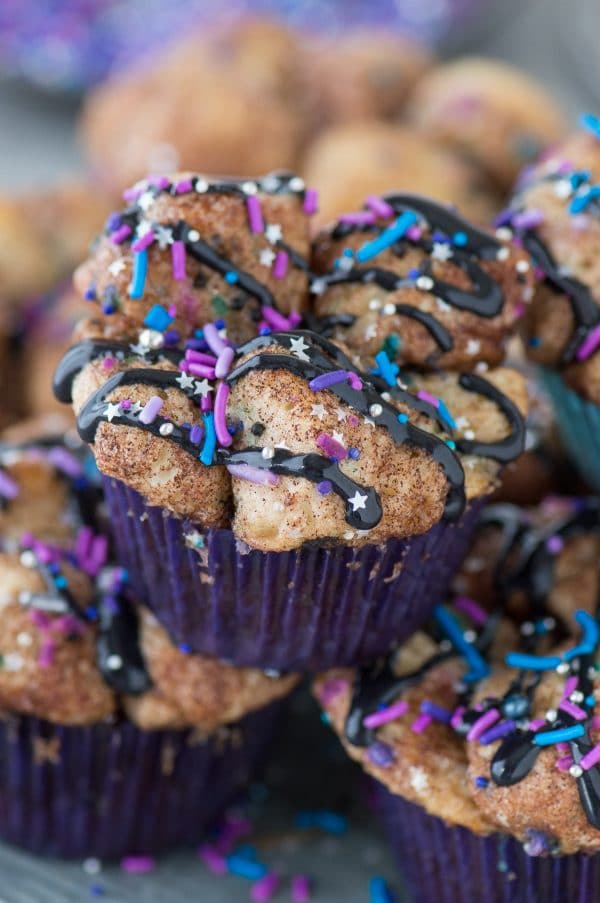 Galaxy Monkey Bread Muffins! Monkey bread turned into muffins with galaxy sprinkles and black cream cheese glaze! These are out of this world! 