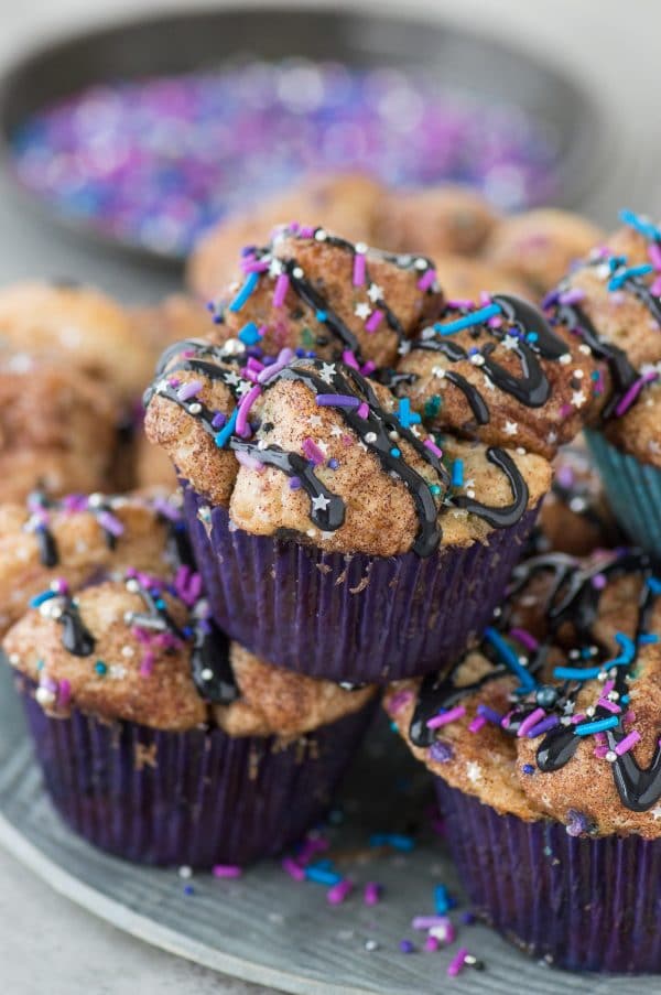 Galaxy Monkey Bread Muffins! Monkey bread turned into muffins with galaxy sprinkles and black cream cheese glaze! These are out of this world! 