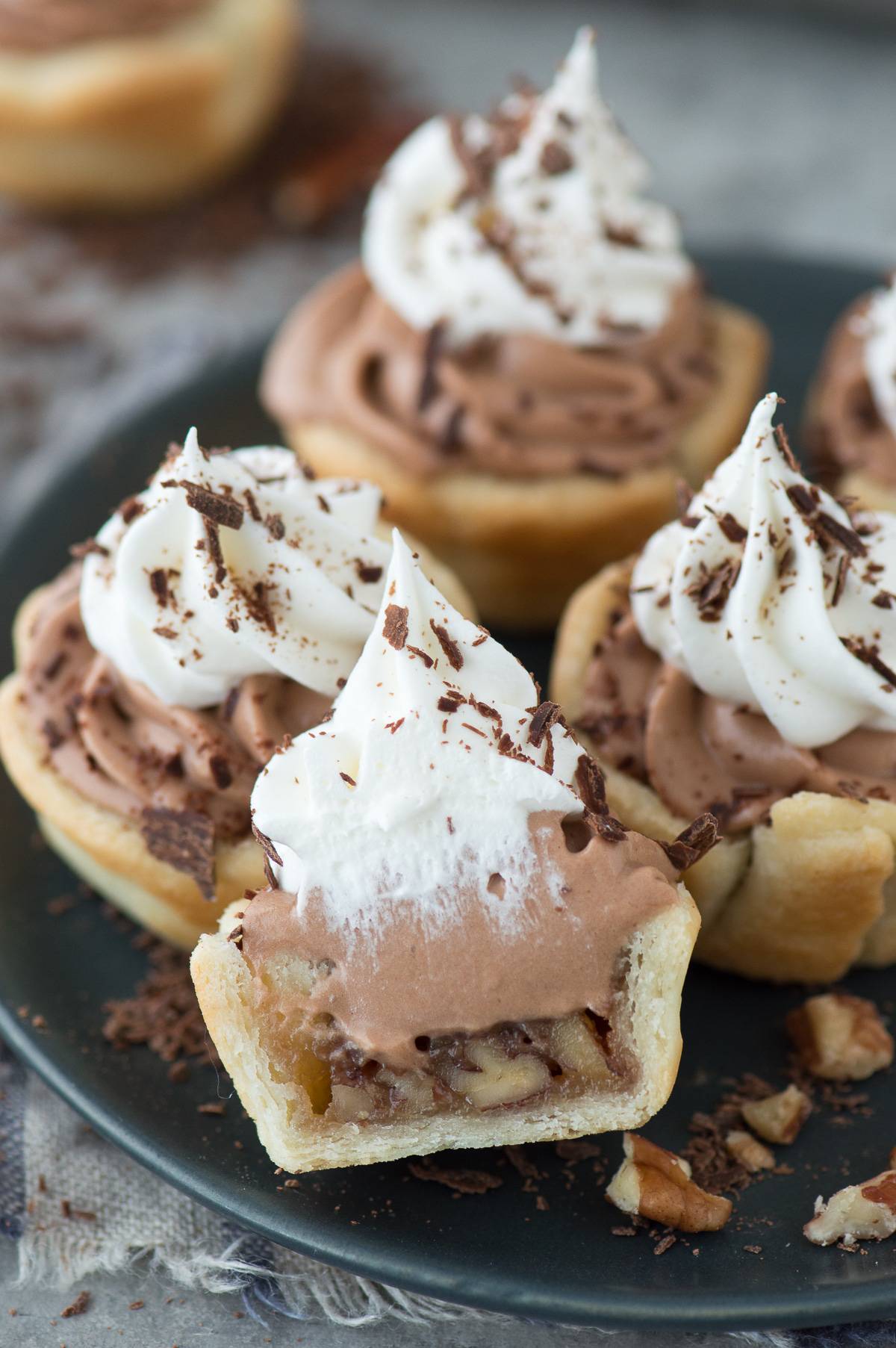 Mini chocolate silk pecan pie bites are the perfect dessert mash-up for Thanksgiving! These mini pies have a pecan pie layer and a chocolate silk layer!