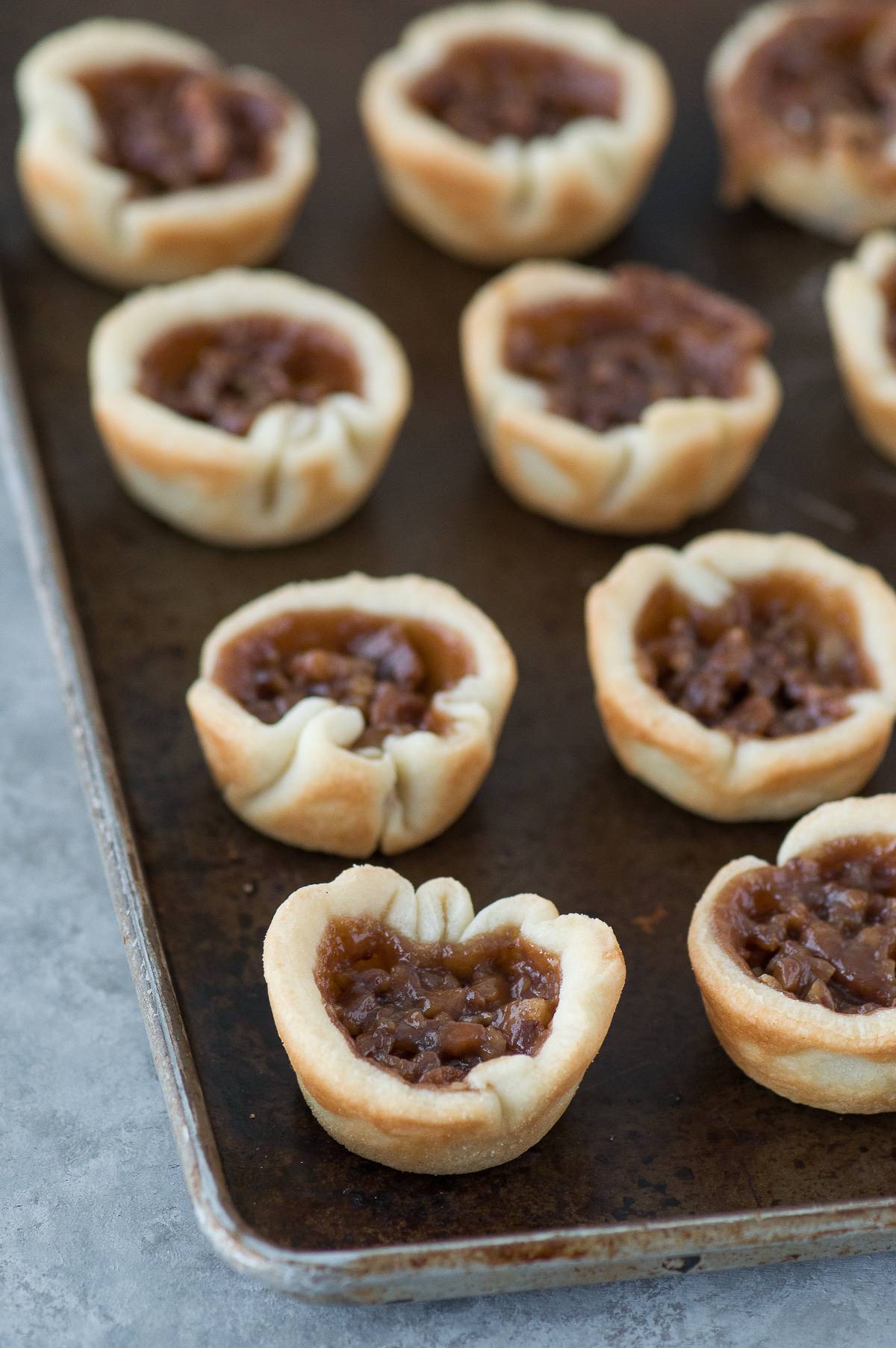 Mini chocolate silk pecan pie bites are the perfect dessert mash-up for Thanksgiving! These mini pies have a pecan pie layer and a chocolate silk layer!
