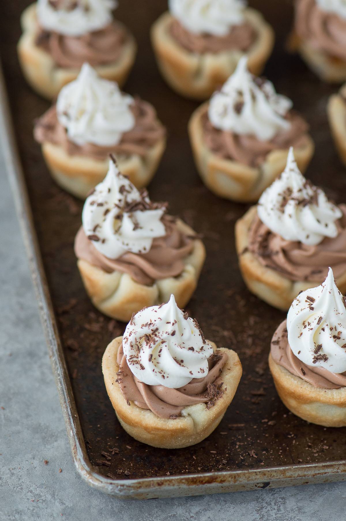 Mini chocolate silk pecan pie bites are the perfect dessert mash-up for Thanksgiving! These mini pies have a pecan pie layer and a chocolate silk layer!