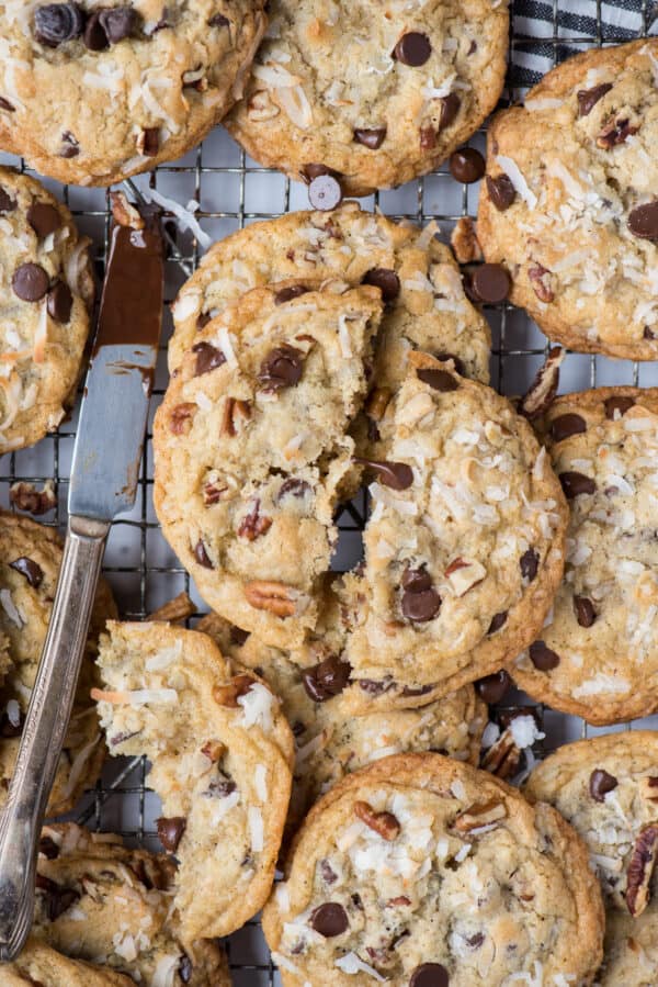 cowboy cookies on wire rack with knife with chocolate on it