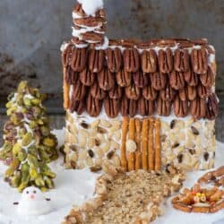 A rustic christmas gingerbread house made using nuts! Learn how to make a gingerbread house out of a butter box, plus tons of decorating ideas and the best gingerbread ‘glue’!