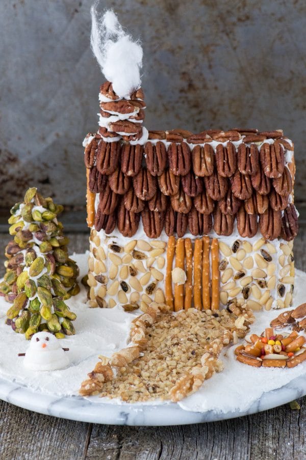 A rustic christmas gingerbread house made using nuts! Learn how to make a gingerbread house out of a butter box, plus tons of decorating ideas and the best gingerbread ‘glue’! 