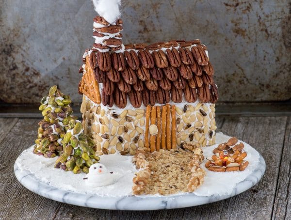 A rustic christmas gingerbread house made using nuts! Learn how to make a gingerbread house out of a butter box, plus tons of decorating ideas and the best gingerbread ‘glue’! 