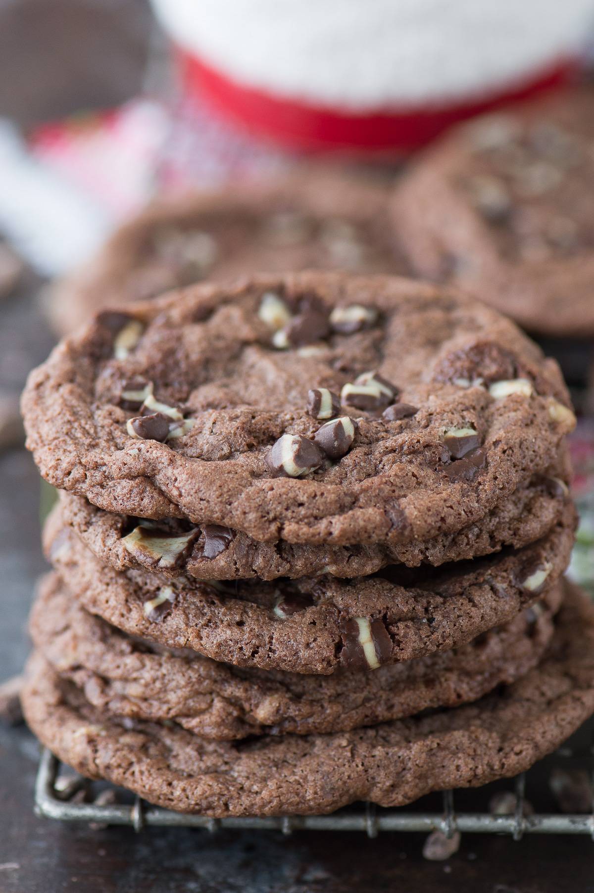 chocolate peppermint cookies stacked on top of each other on dark background