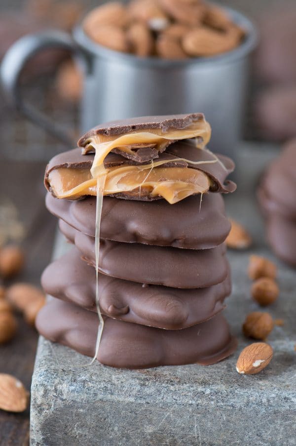 sticky paws (chocolate caramel nut cluster) in a stack with gooey caramel