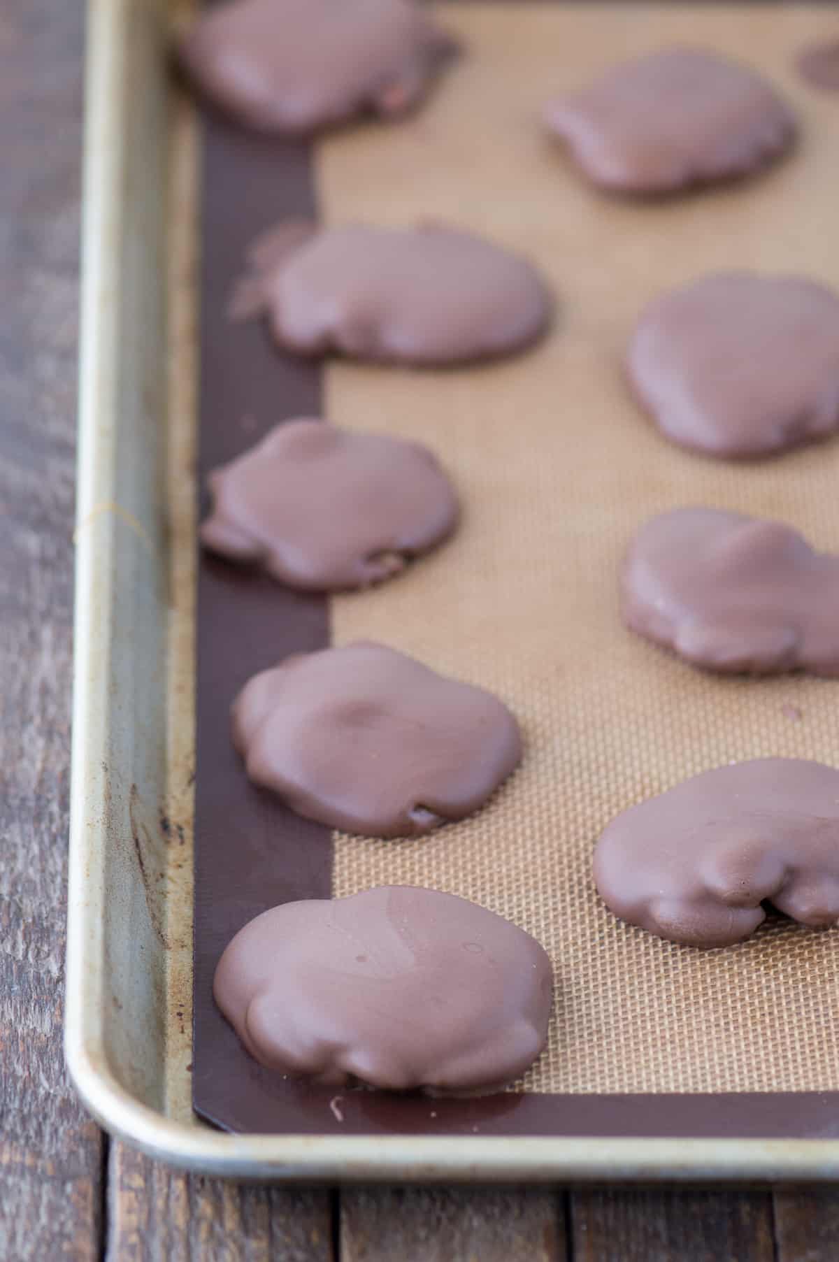 almond caramel chocolate clusters on silicone baking mat
