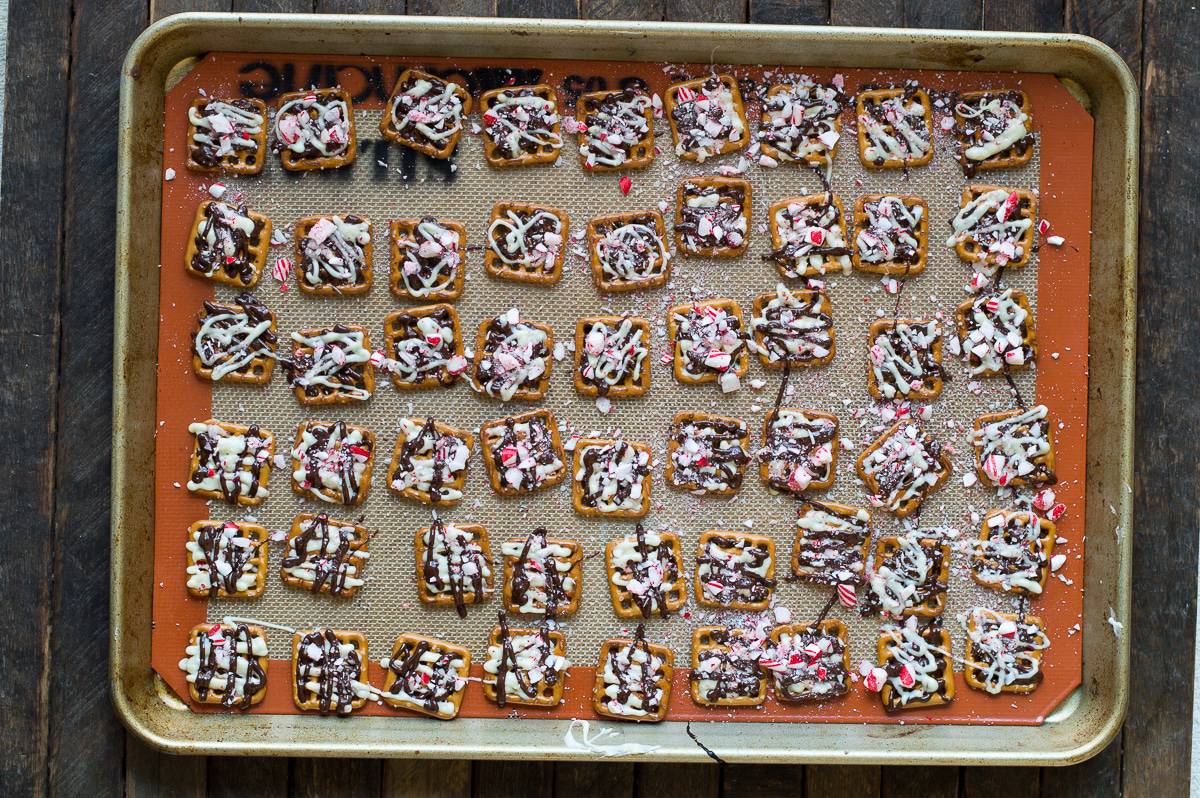 peppermint bark pretzels arranged on metal baking sheet