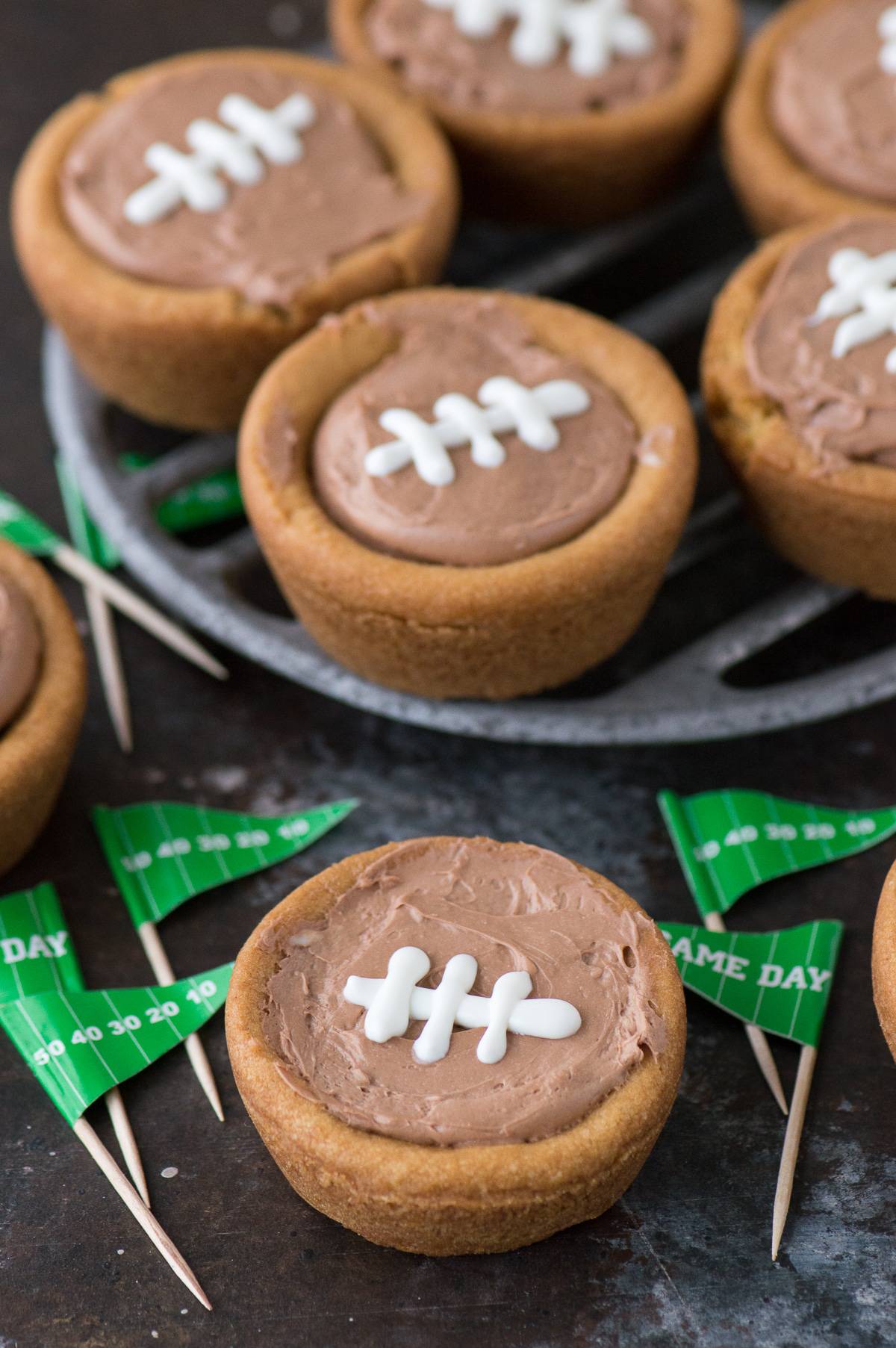 A fun game day dessert - cheesecake sugar cookie football cups on a serving plate.
