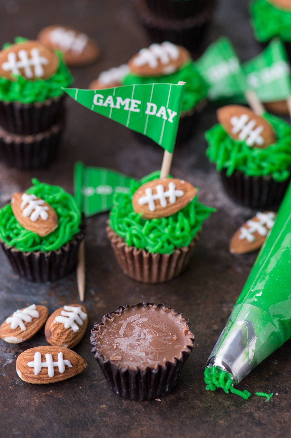 These reese’s peanut butter football cups are the easiest game treat! You need peanut butter cups, green frosting and football almonds!