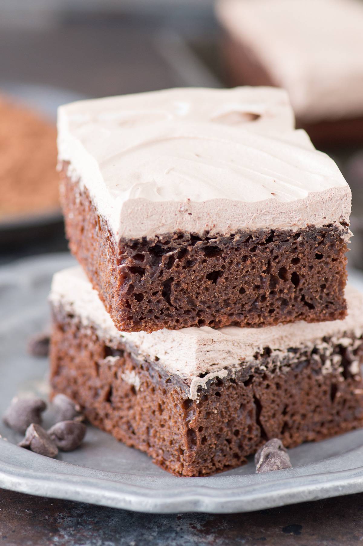 two slices of healthy chocolate cake stacked on each other on metal plate