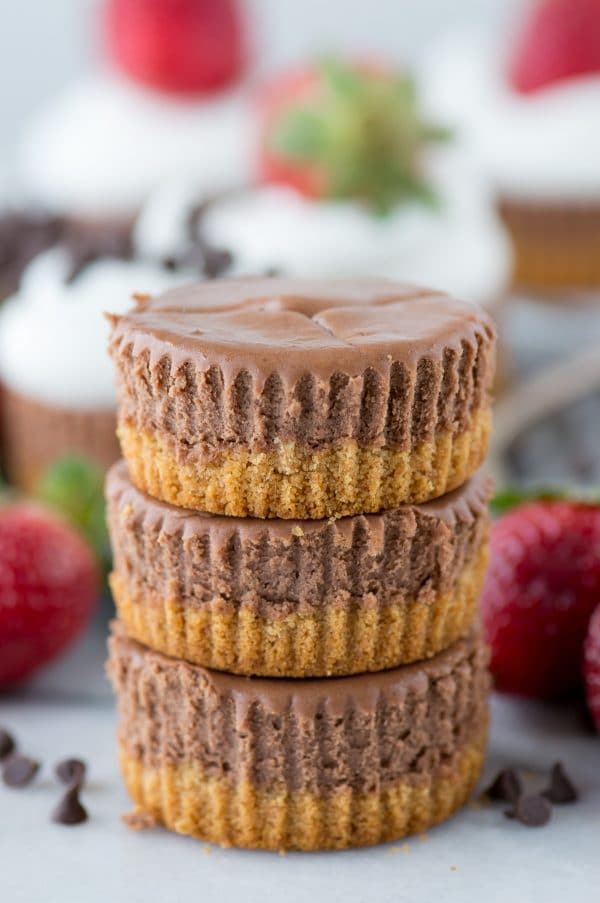 mini chocolate cheesecakes stacked 3 high on white background