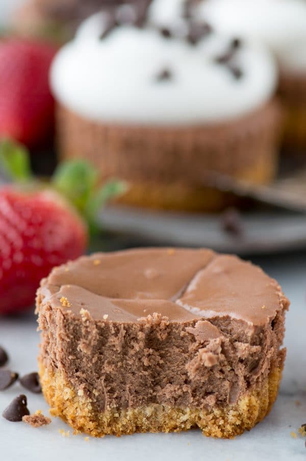 mini chocolate cheesecake with bite on white background