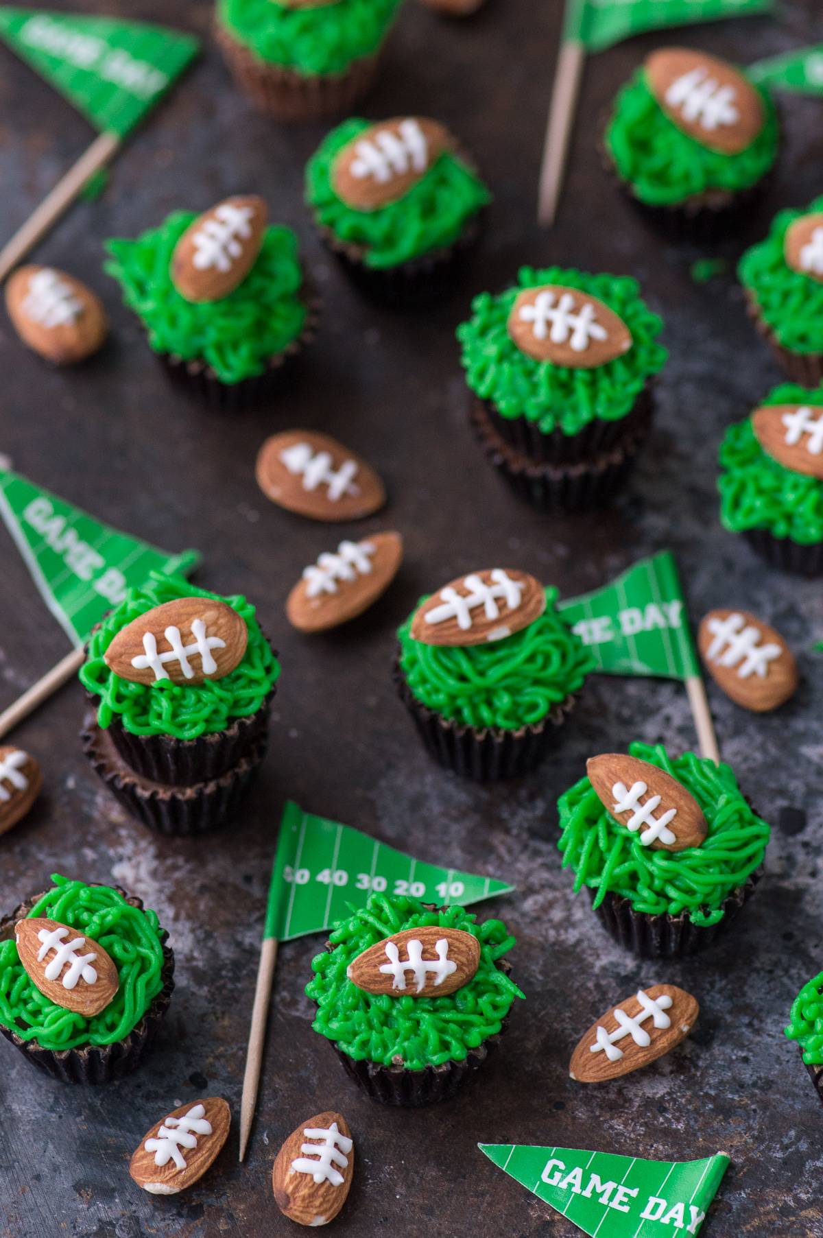 These reese’s peanut butter football cups are the easiest game treat! You need peanut butter cups, green frosting and football almonds!