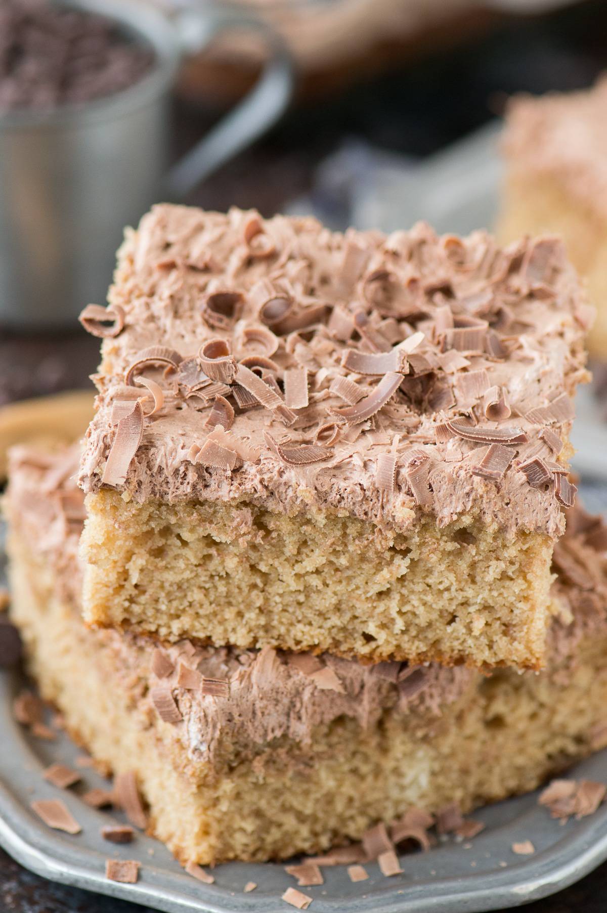 slice of peanut butter cake with chocolate frosting on metal plate