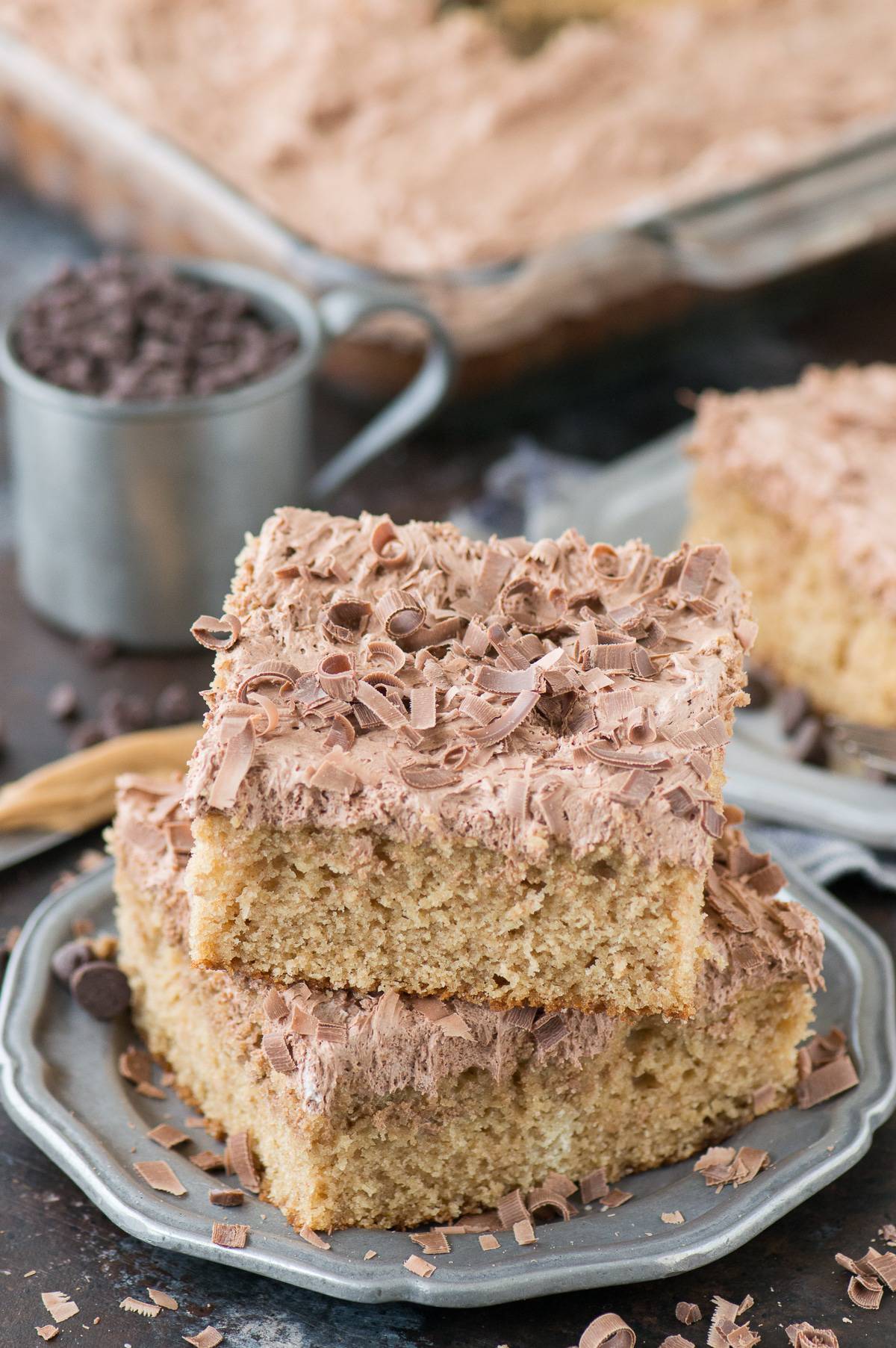 slice of peanut butter cake with chocolate frosting on metal plate