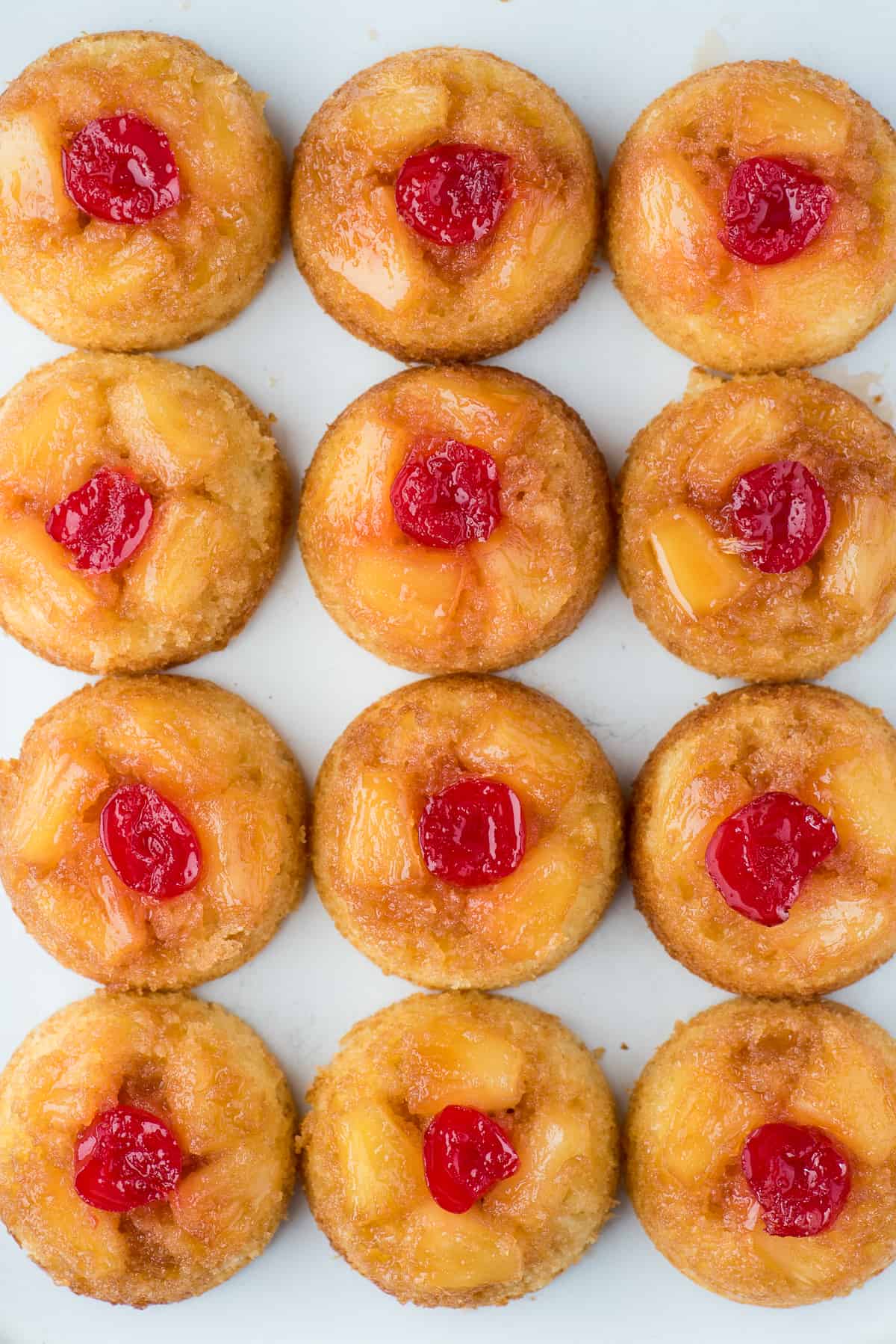 mini pineapple upside down cakes in a grid pattern on white background