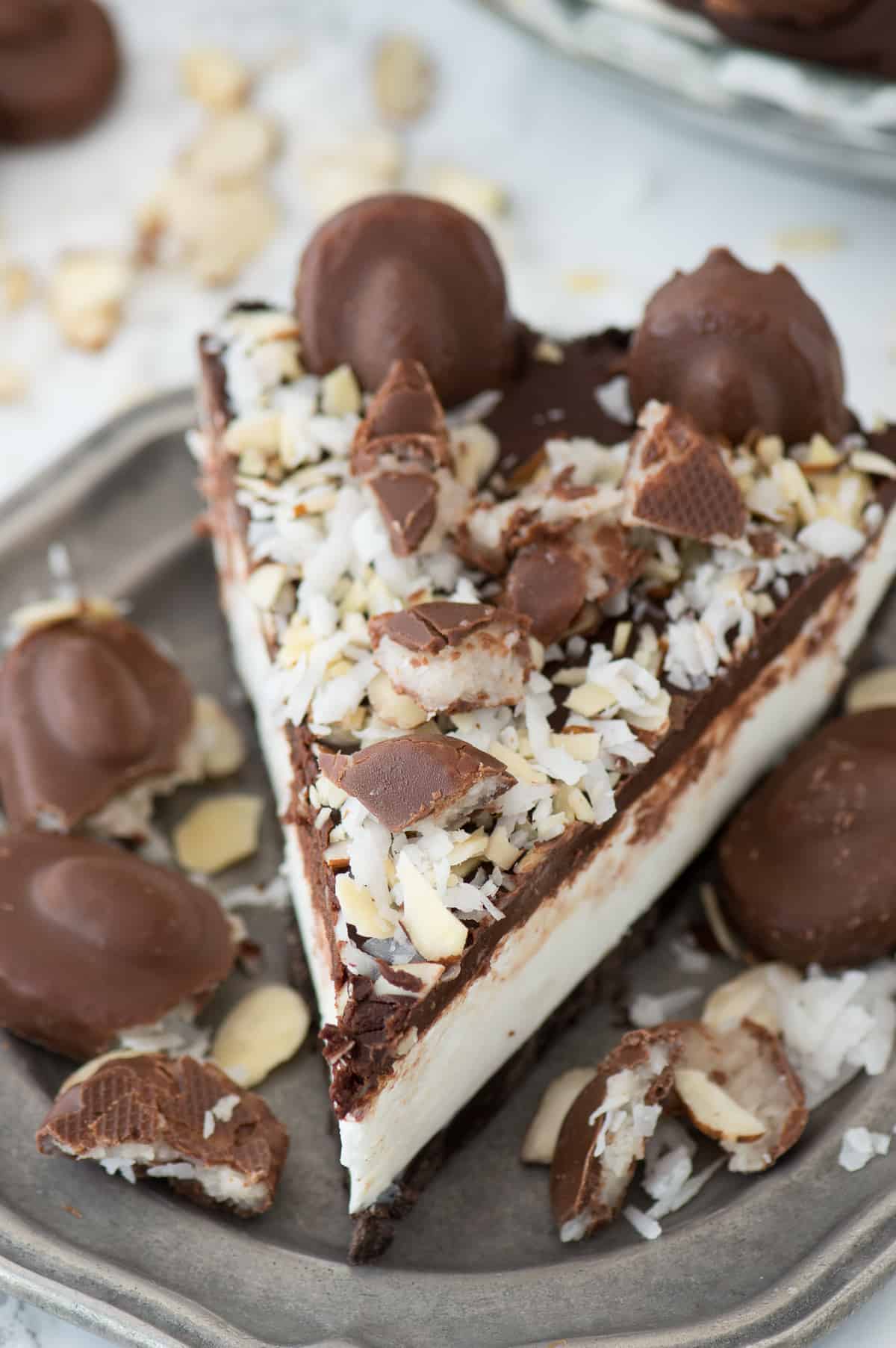 No bake almond joy pie with an oreo crust, creamy coconut filling, chocolate ganache and topped with all the components of an Almond Joy candy bar! 