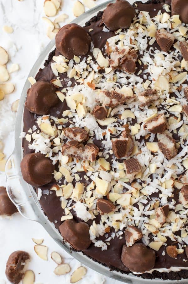 No bake almond joy pie with an oreo crust, creamy coconut filling, chocolate ganache and topped with all the components of an Almond Joy candy bar! 