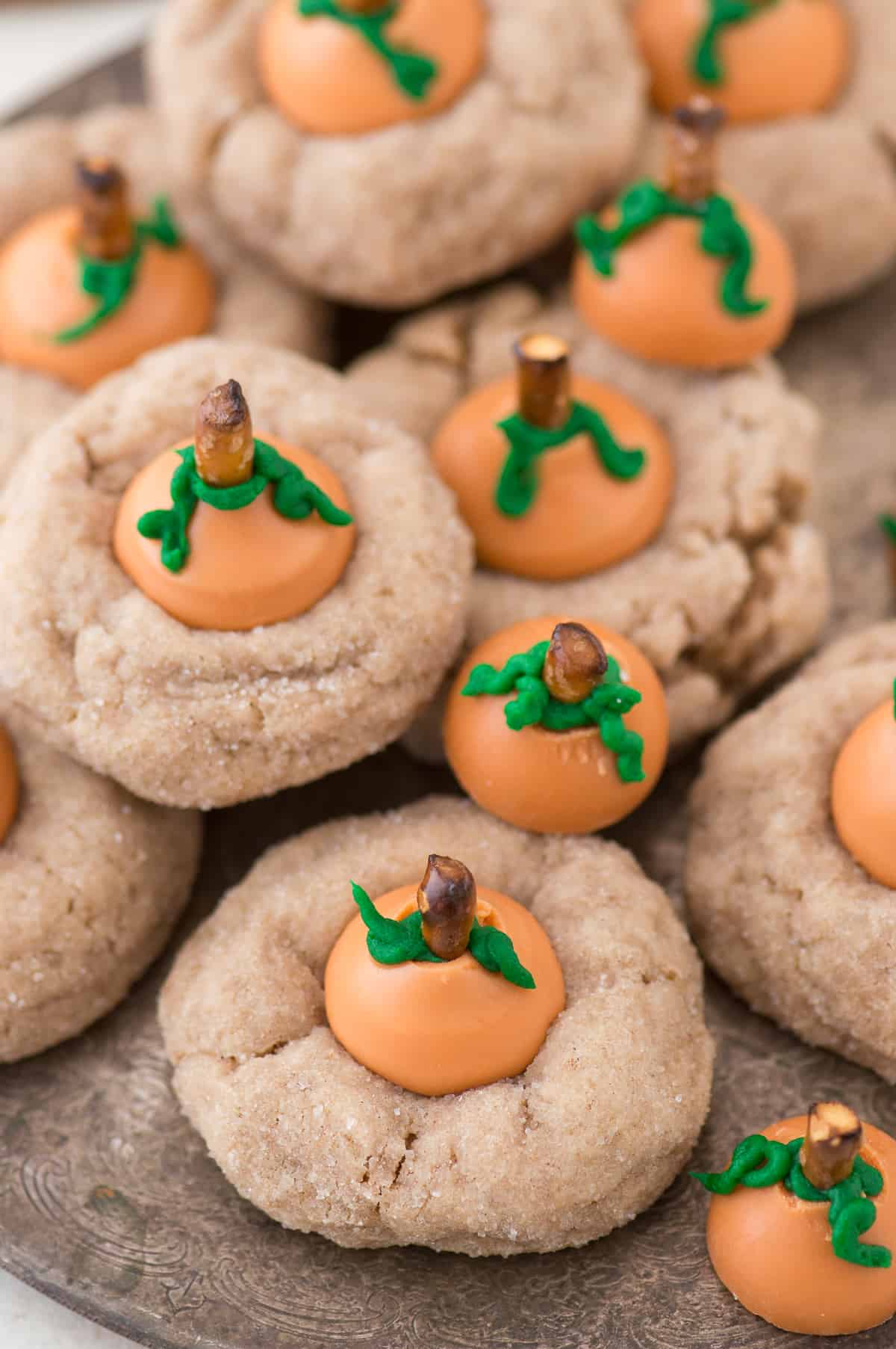 These are the most adorable fall cookies - pumpkin blossom cookies! A spice cookie with pumpkin spice hershey’s kisses turned into PUMPKINS!