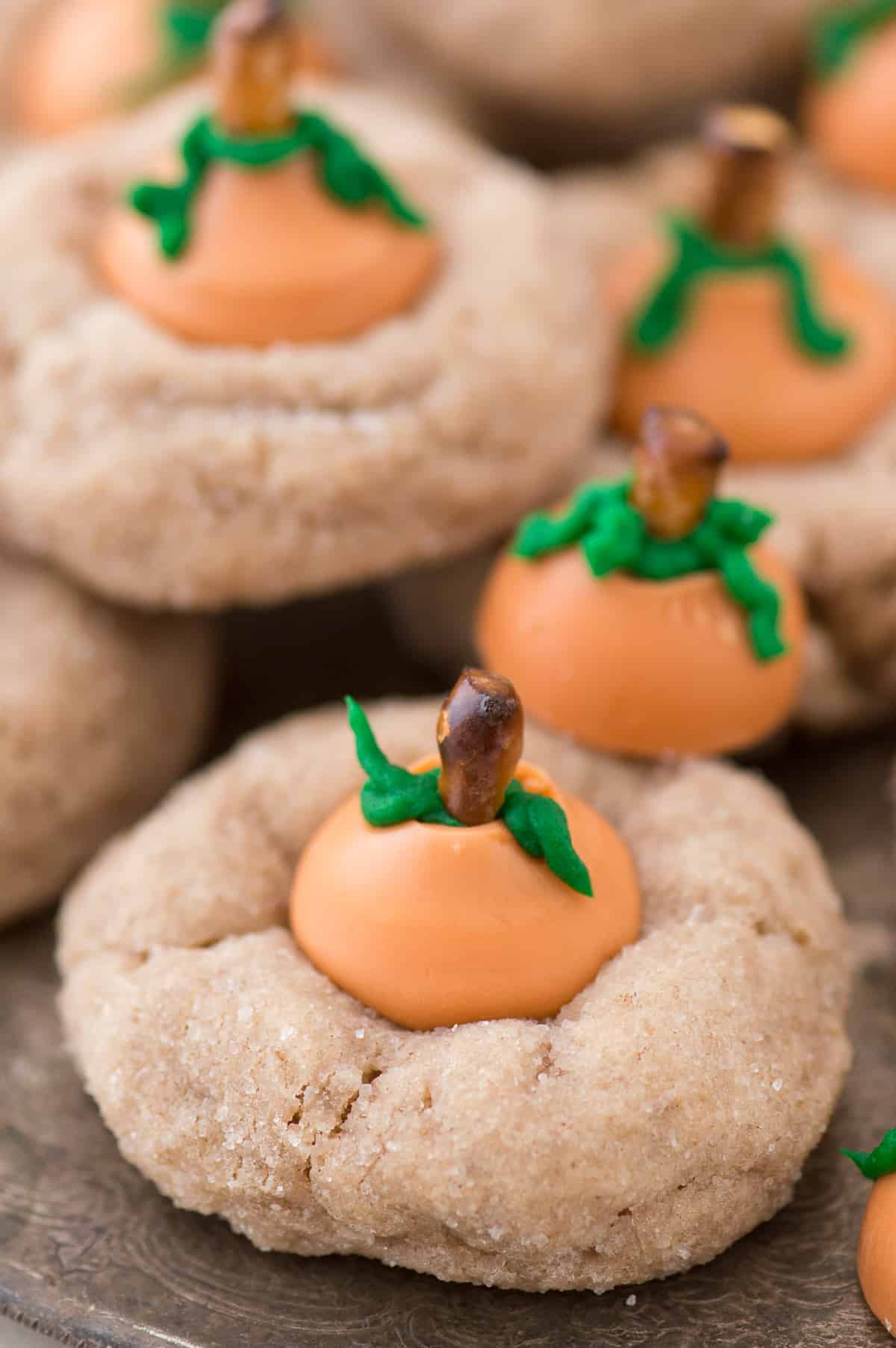 These are the most adorable fall cookies - pumpkin blossom cookies! A spice cookie with pumpkin spice hershey’s kisses turned into PUMPKINS!