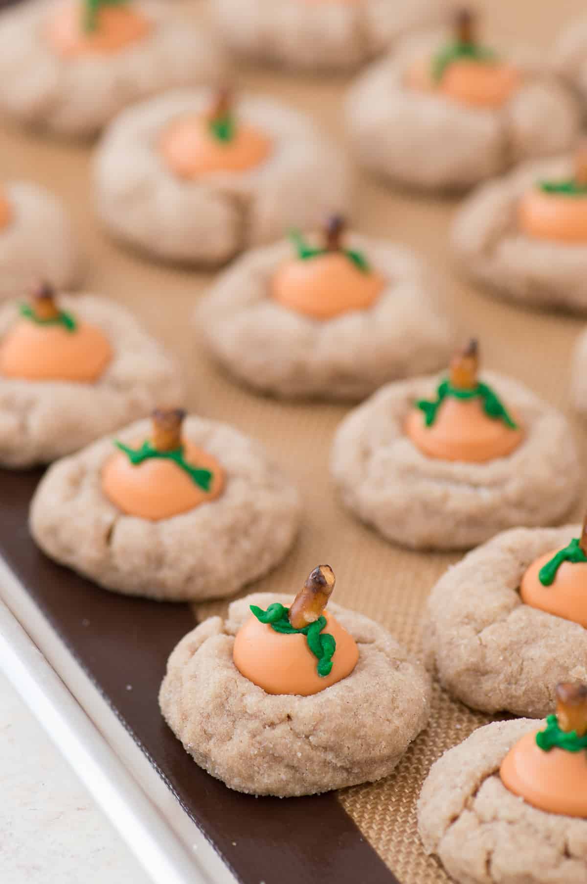These are the most adorable fall cookies - pumpkin blossom cookies! A spice cookie with pumpkin spice hershey’s kisses turned into PUMPKINS!