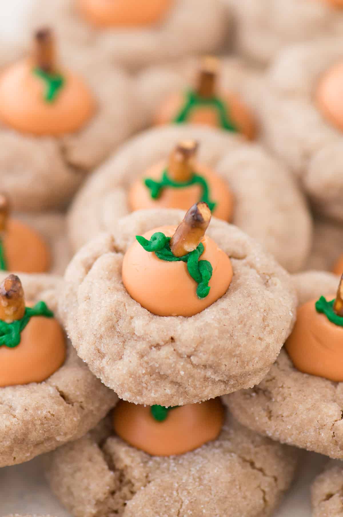 These are the most adorable fall cookies - pumpkin blossom cookies! A spice cookie with pumpkin spice hershey’s kisses turned into PUMPKINS!
