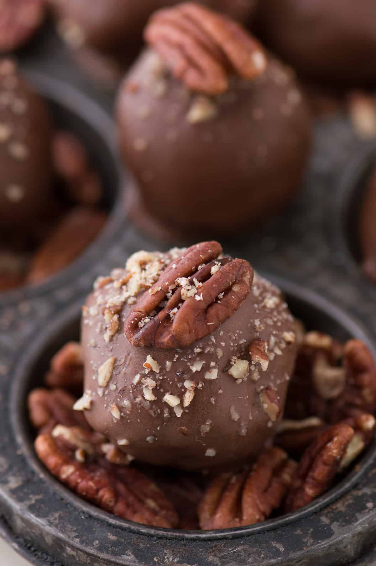 oreo balls covered in chocolate with pecan on top