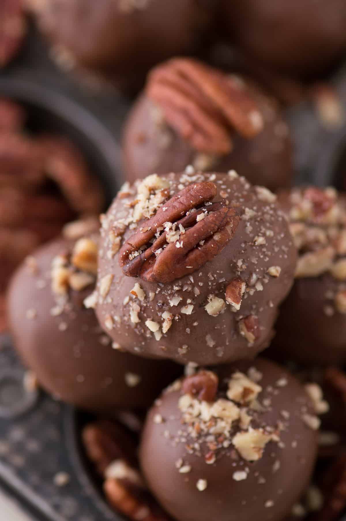 oreo balls covered in chocolate with pecan on top