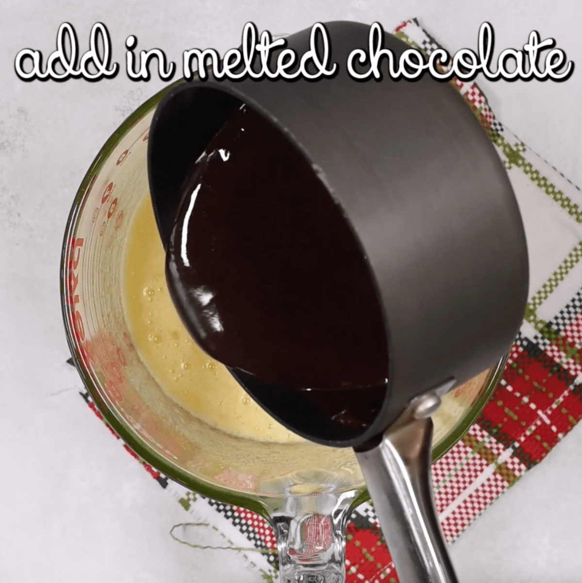 adding melted chocolate to cookie dough