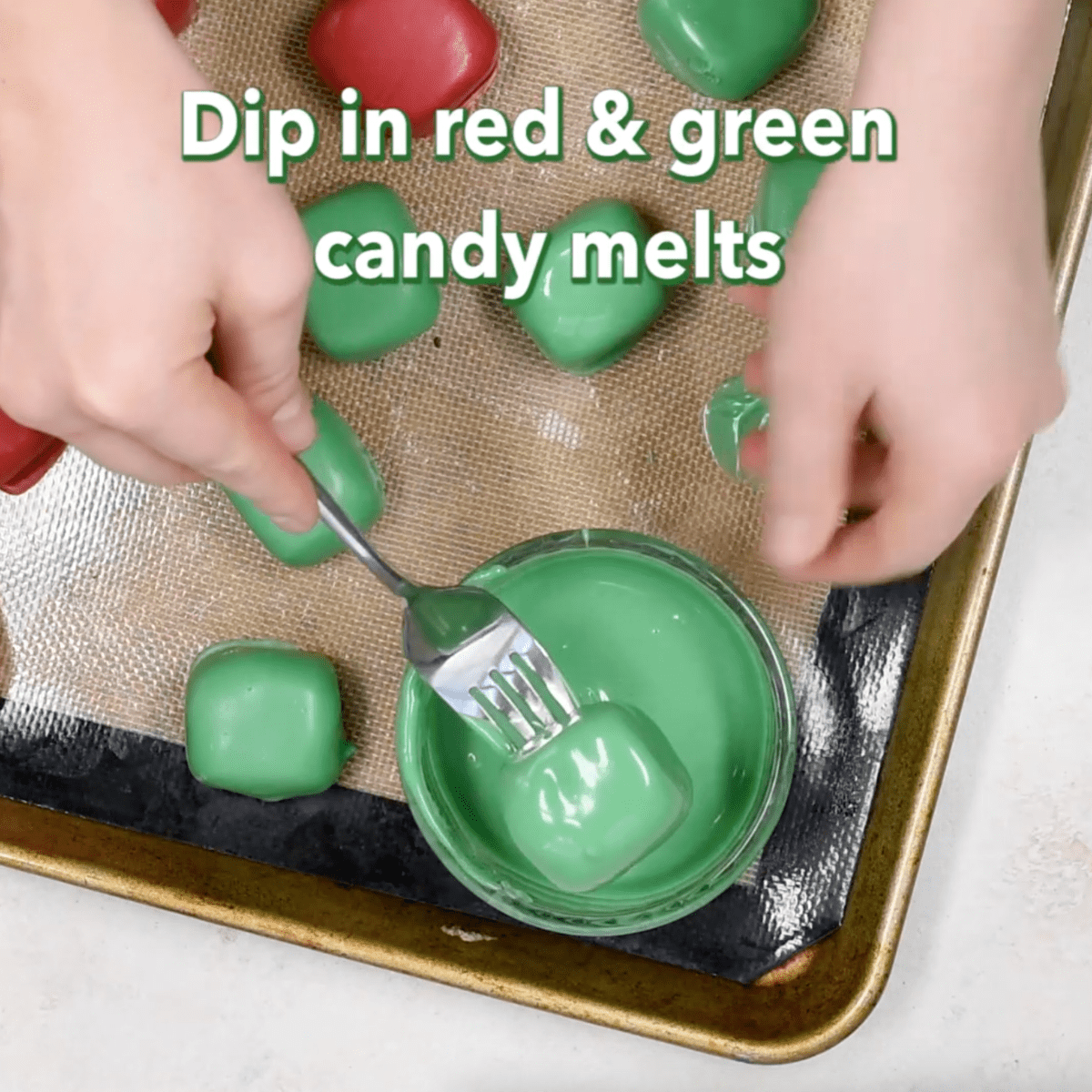 dipping oreo balls into green melted chocolate