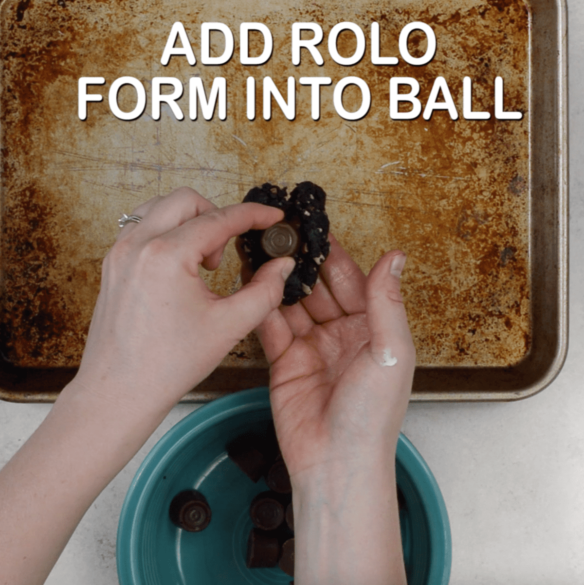 hands roll oreo ball that's stuffed with a rolo