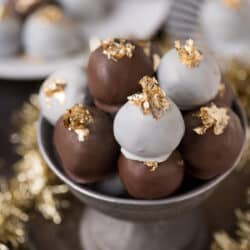 Gold and glittery New Year’s Eve oreo balls! Dipped in chocolate and white chocolate, decorated with edible gold leaf! Plus there is a star sprinkle hidden inside each!