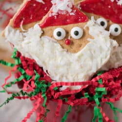 Easy to make Santa Graham Crackers are the perfect edible treat to make at home with your kids or at a school Christmas party! You can buy all the supplies at the grocery store, ZERO prep involved!