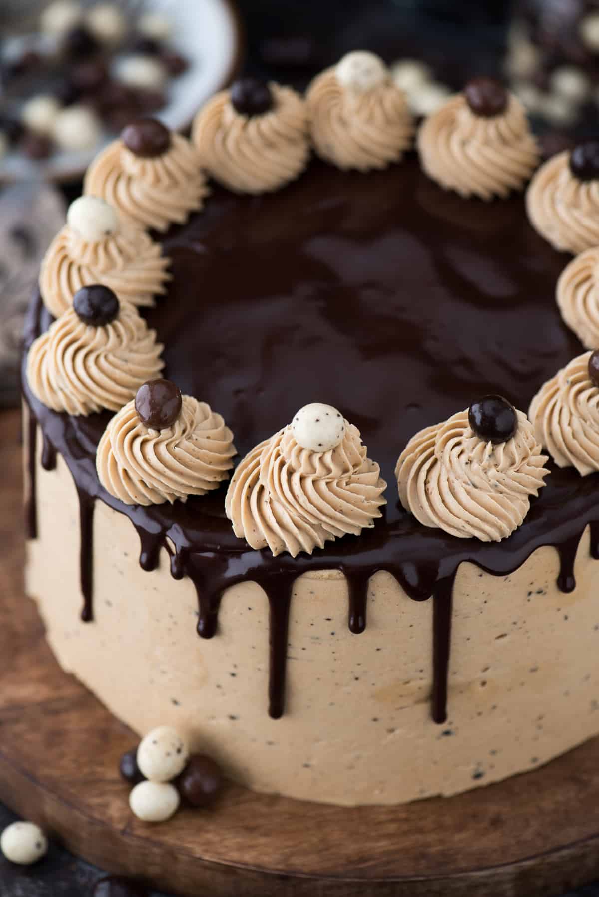 whole chocolate cofee cake on wooden tray on dark background