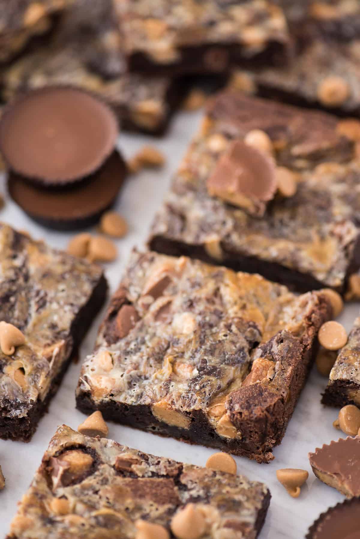 reese's magic bars cut into squares and arranged in grid on white surface