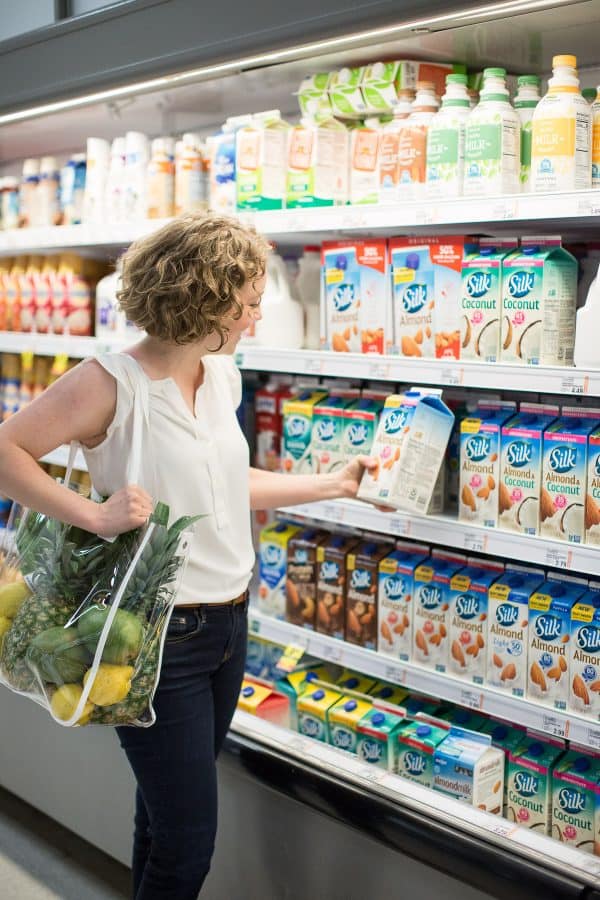 woman shopping for brand product in a grocery store 