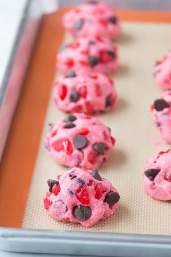 pink maraschino cherry chocolate chip cookies on baking sheet before baking
