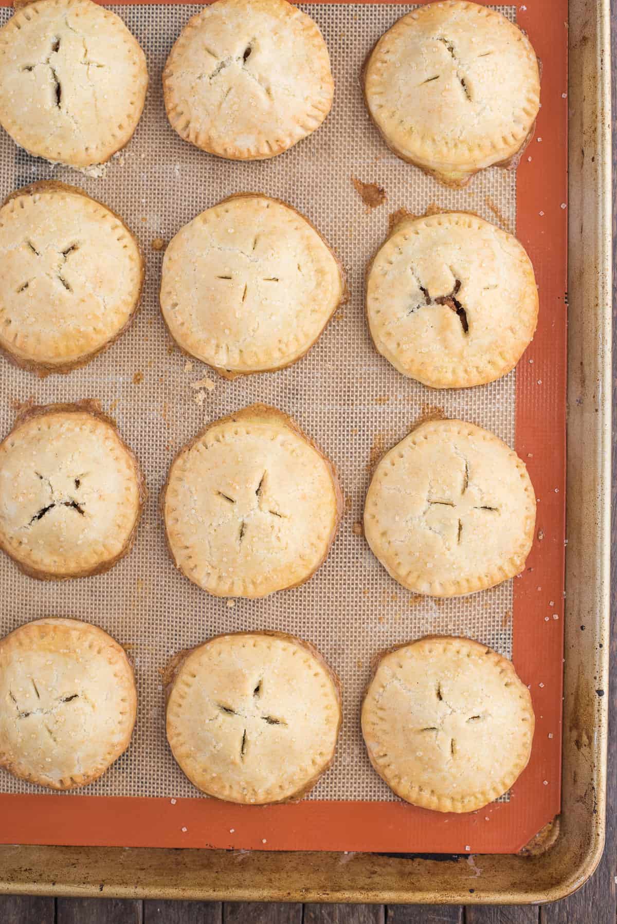 apple hand pies on a silicone lined baking sheet 