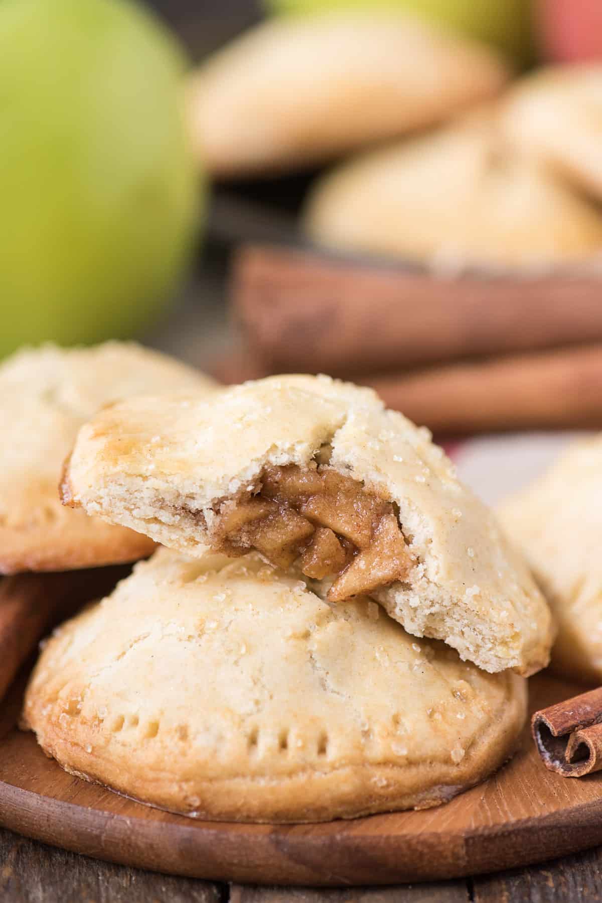apple hand pies on wood background with green apple in the background