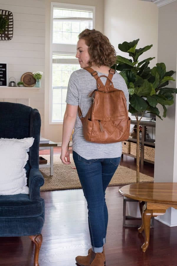 Woman wearing cognac colored back pack purse from Amazon 