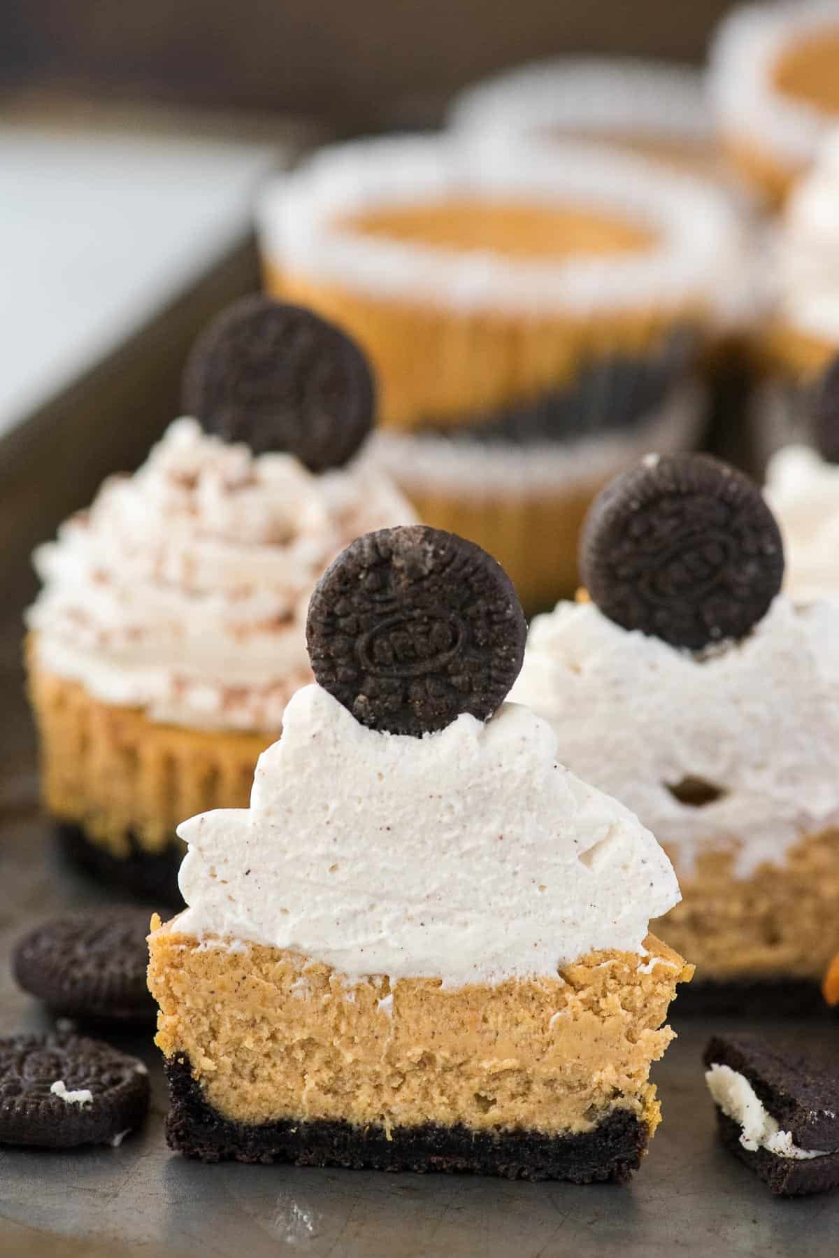 mini pumpkin cheesecake with oreo cookie crust cut in half